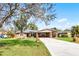 Charming single-story home with a well-manicured lawn and covered parking at 2003 Woodcrest Dr, Winter Park, FL 32792