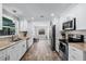Well-lit kitchen with white cabinets, stainless steel appliances, and an inviting design at 2003 Woodcrest Dr, Winter Park, FL 32792
