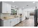 Modern kitchen featuring white cabinetry, stainless steel appliances, and stylish backsplash at 2003 Woodcrest Dr, Winter Park, FL 32792