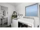 Functional laundry room with washer, dryer, water heater and utility sink at 2003 Woodcrest Dr, Winter Park, FL 32792