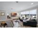 Comfortable living room featuring a plush sofa, stylish rug, and ample natural light at 2003 Woodcrest Dr, Winter Park, FL 32792
