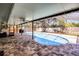 Screened-in pool area with brick pavers and a private backyard view at 2003 Woodcrest Dr, Winter Park, FL 32792