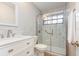 Modern bathroom featuring a marble tiled shower with glass door and white vanity at 2007 Cornell Pl # 4, Port Orange, FL 32128