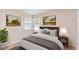 Cozy bedroom with two windows providing natural light and a bed with a comfortable gray blanket at 2007 Cornell Pl # 4, Port Orange, FL 32128