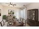 Dining area features tile floors, sliding glass door, and dark wood furniture with elegant dishware at 2007 Cornell Pl # 4, Port Orange, FL 32128