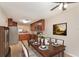 Dining area with tile floors, ceiling fan, stylish furniture, and adjacent open kitchen at 2007 Cornell Pl # 4, Port Orange, FL 32128