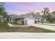 Charming single-story home features a two-car garage, well-manicured lawn, and mature landscaping at 2007 Cornell Pl # 4, Port Orange, FL 32128