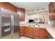Kitchen features stainless steel refrigerator and countertops with an open view to the living space at 2007 Cornell Pl # 4, Port Orange, FL 32128