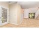 Open-concept living area with tile flooring, light walls, and sliding door that leads to backyard at 2007 Cornell Pl # 4, Port Orange, FL 32128