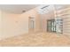 Spacious living room with tile floors, vaulted ceiling with light, and sliding doors to a balcony at 2007 Cornell Pl # 4, Port Orange, FL 32128