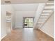 Open living area with tile flooring, stairs, slider to backyard, and plenty of natural light at 2007 Cornell Pl # 4, Port Orange, FL 32128
