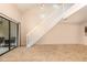 Bright living room area featuring a staircase, sliding glass doors, and tile flooring at 2007 Cornell Pl # 4, Port Orange, FL 32128