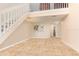 Open-concept living area with stairway, passthrough to kitchen, and views to upper level at 2007 Cornell Pl # 4, Port Orange, FL 32128