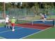 Active pickleball courts with players in action on a sunny day behind a chain link fence at 2007 Cornell Pl # 4, Port Orange, FL 32128