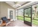 Relax on this screened porch with views of the lush backyard and pond at 2007 Cornell Pl # 4, Port Orange, FL 32128