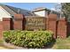 Cypress Lake Townhomes community sign with brick pillars and lush landscaping at 2190 Cypress Bay Blvd, Kissimmee, FL 34743