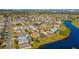 An aerial view of a suburban neighborhood with homes surrounding a large, tranquil lake on a sunny day at 3109 Bear Path, Kissimmee, FL 34746