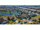 Aerial view of a community with homes surrounding a lake at 3109 Bear Path, Kissimmee, FL 34746