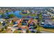 Aerial view of the home and community with a beautiful lake and mature landscaping at 3109 Bear Path, Kissimmee, FL 34746