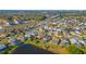 An aerial view of a suburban neighborhood featuring well-maintained homes and lush landscaping near a serene lake at 3109 Bear Path, Kissimmee, FL 34746