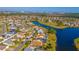 Aerial view of a neighborhood with a scenic lake and lush green spaces at 3109 Bear Path, Kissimmee, FL 34746