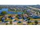 Aerial view of a community with homes surrounding a lake at 3109 Bear Path, Kissimmee, FL 34746