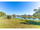 Expansive backyard with lush green grass and a picturesque view of the tranquil lake at 3109 Bear Path, Kissimmee, FL 34746