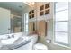 Bright bathroom featuring a combination shower and bathtub with decorative wall art and marble countertop at 3109 Bear Path, Kissimmee, FL 34746