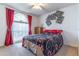 Bright bedroom with vaulted window, and neutral carpeting at 3109 Bear Path, Kissimmee, FL 34746