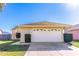 Attached garage with white door, trimmed hedges and brick details on a sunny day at 3109 Bear Path, Kissimmee, FL 34746