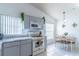 Bright eat-in kitchen features white appliances, gray cabinets, marble-look countertops, and a dining area at 3109 Bear Path, Kissimmee, FL 34746