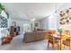 Bright living room with a large window overlooking the backyard, a cozy couch, and a ceiling fan at 3109 Bear Path, Kissimmee, FL 34746