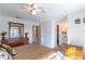 Inviting main bedroom with neutral carpeting, a ceiling fan, and a dresser with a large mirror at 3109 Bear Path, Kissimmee, FL 34746