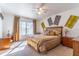 Sunlit main bedroom with neutral carpeting, matching nightstands and gold decor at 3109 Bear Path, Kissimmee, FL 34746