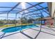 Enclosed pool area with a view of the lake and seating area at 3109 Bear Path, Kissimmee, FL 34746