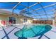 Enclosed pool area with a covered lanai, a table, and chairs, offering a relaxing outdoor space at 3109 Bear Path, Kissimmee, FL 34746