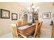 Elegant dining area with a wood table, chandelier, archway, and neutral tones for a welcoming atmosphere at 3432 Capland Ave, Clermont, FL 34711