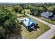 Aerial view of the charming home with metal roof, shed, and lush green lawn at 3512 Central Ave, Coleman, FL 33521