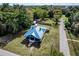 Aerial view of the charming home with metal roof, shed, and lush green lawn at 3512 Central Ave, Coleman, FL 33521