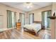 Bright bedroom featuring wood floors, natural light, and a ceiling fan at 3512 Central Ave, Coleman, FL 33521