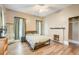 Spacious bedroom with wood floors, plenty of natural light, and a brick fireplace at 3512 Central Ave, Coleman, FL 33521