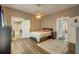 Warm bedroom with wood floors, and attached bathroom at 3512 Central Ave, Coleman, FL 33521