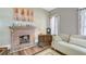 Living room featuring a brick fireplace, hardwood floors, and natural light at 3512 Central Ave, Coleman, FL 33521