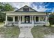 Inviting home with a covered front porch, white railings and columns, offering an ideal spot for relaxation at 3512 Central Ave, Coleman, FL 33521