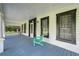 Inviting front porch features ample seating and offers a perfect spot to relax and enjoy the outdoors at 3512 Central Ave, Coleman, FL 33521