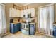 Well-lit kitchen with white cabinets and updated appliances at 3512 Central Ave, Coleman, FL 33521