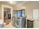 Bright laundry room with washer and dryer, closet, and adjacent bathroom at 3512 Central Ave, Coleman, FL 33521