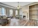 Cozy living room with a brick fireplace, beautiful floors, and natural light at 3512 Central Ave, Coleman, FL 33521
