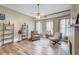 Inviting living room featuring neutral paint, wood floors, and a decorative fireplace at 3512 Central Ave, Coleman, FL 33521