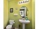 Charming half bath with bright green walls and vanity at 3528 Seneca Club Loop # 103 - C, Orlando, FL 32808